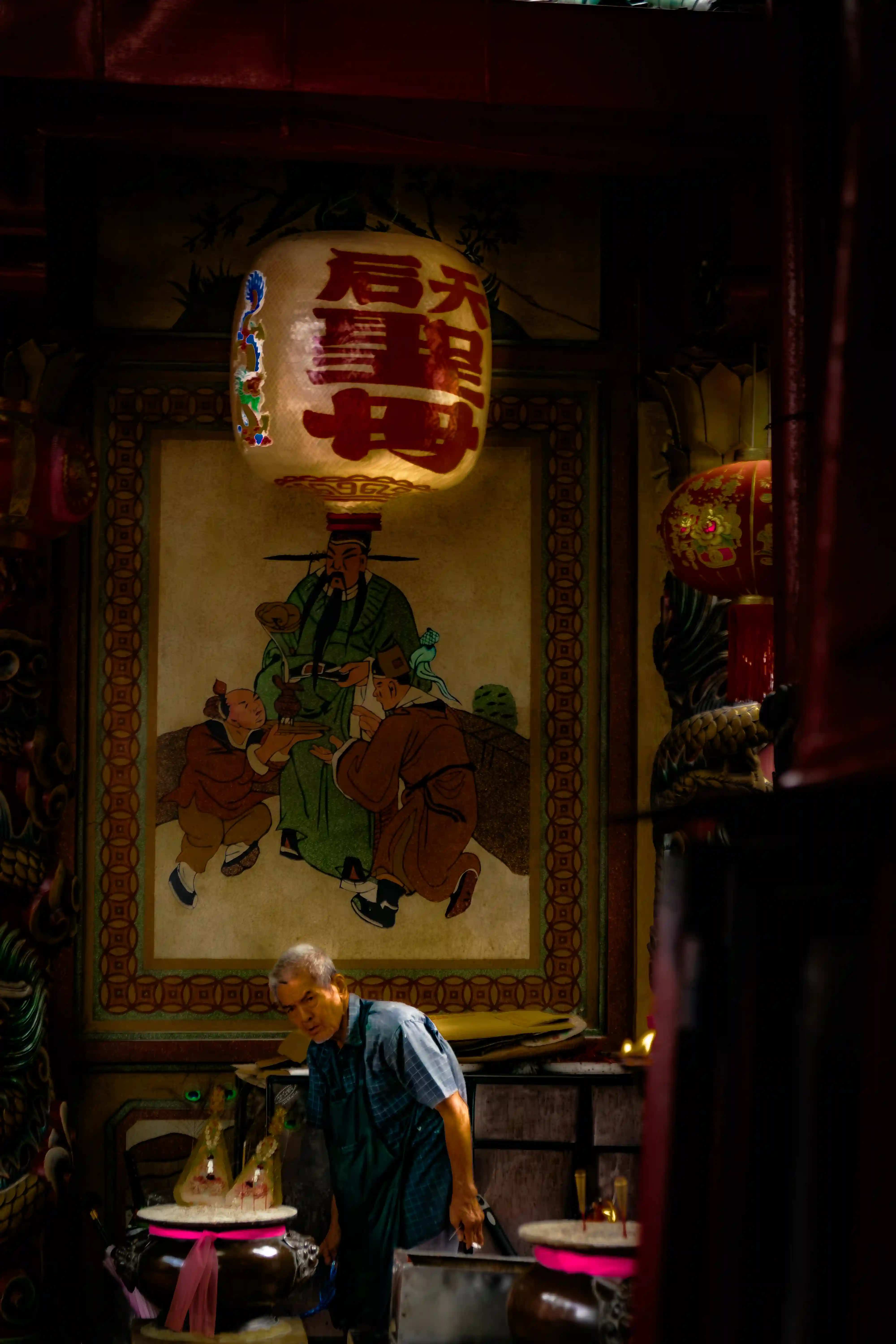 Interior — incense, red light, and offerings